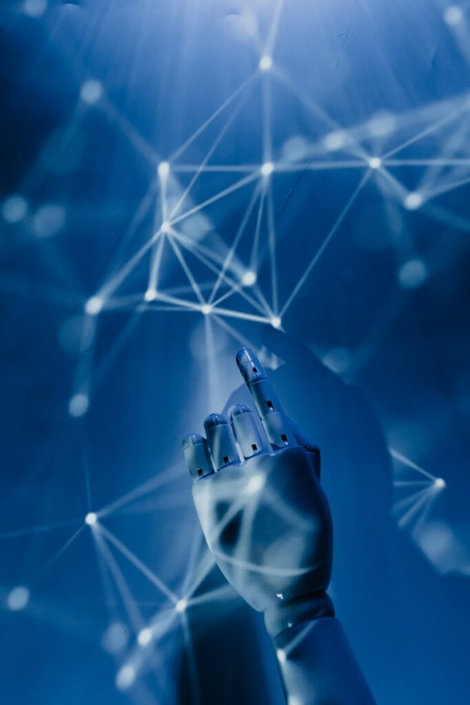 A robotic hand reaching into a digital network on a blue background, symbolizing AI technology.